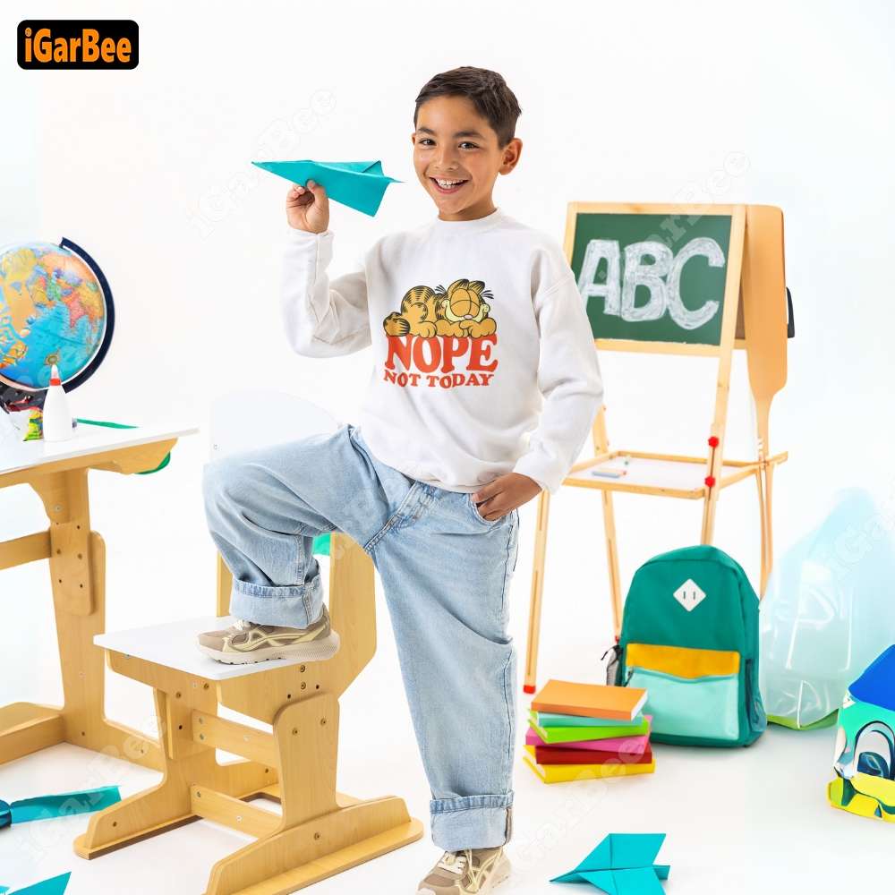 Graphic white Garfield sweatshirts for kids, size S, styled with jeans and sneakers for a comfortable look in class.