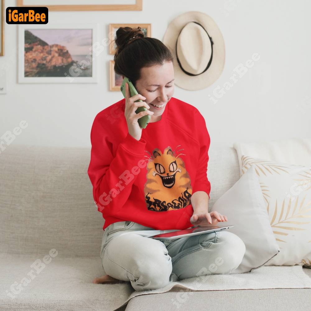Relaxed woman in a red Garfield sweatshirt, size L, sitting comfortably in the living room.
